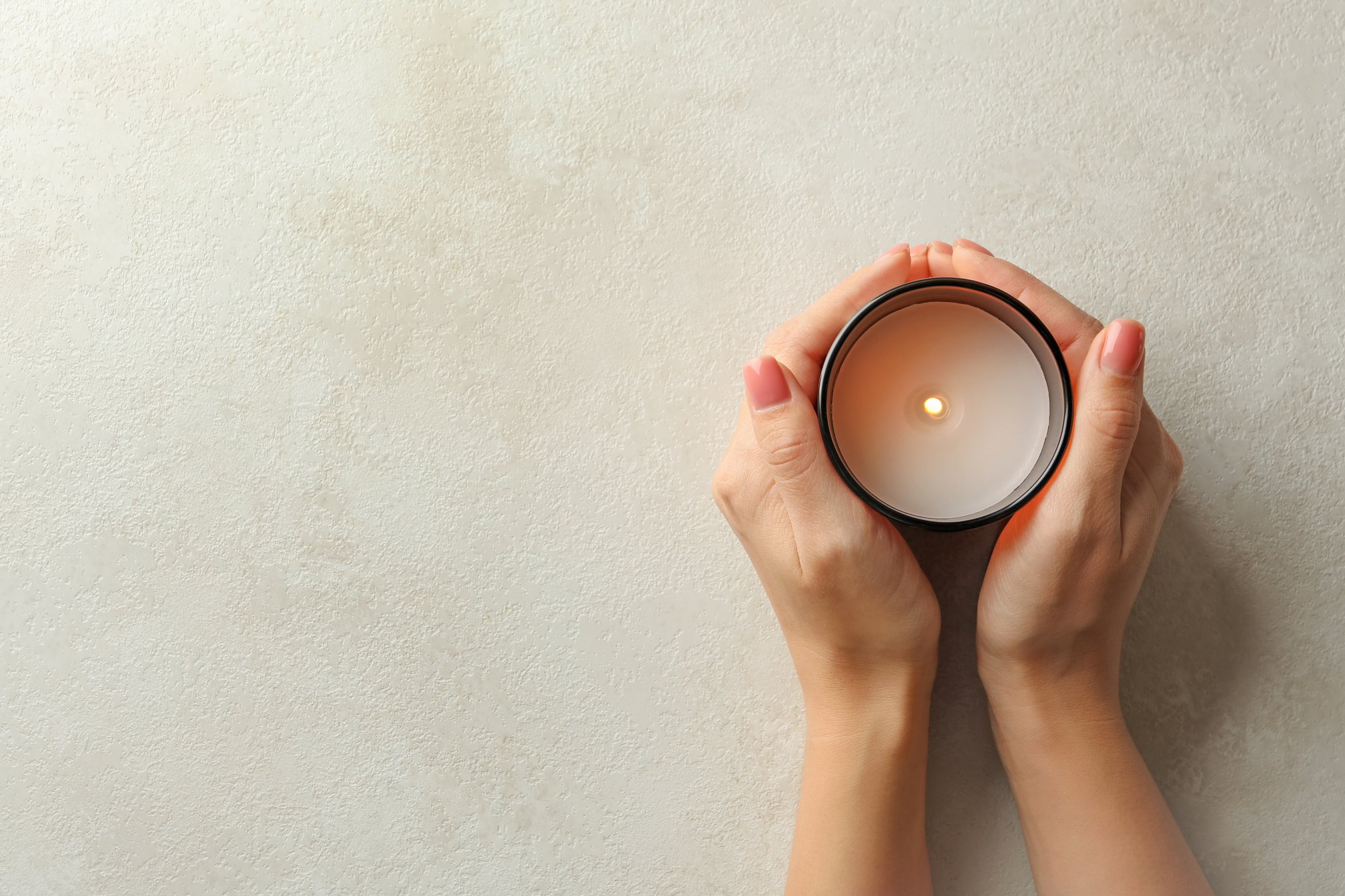 Female Hands Holding Scented Candle